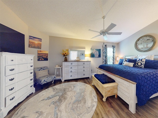 bedroom featuring dark hardwood / wood-style flooring, a textured ceiling, and ceiling fan