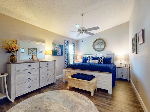 bedroom featuring dark hardwood / wood-style flooring, a textured ceiling, vaulted ceiling, and ceiling fan