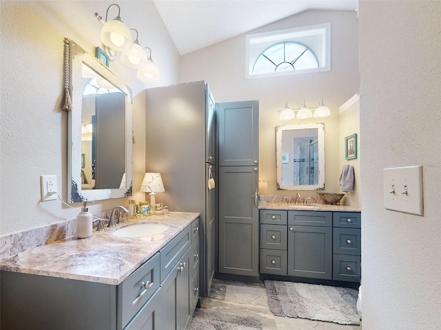 bathroom with lofted ceiling and vanity