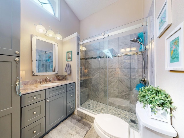 bathroom with walk in shower, vanity, and toilet