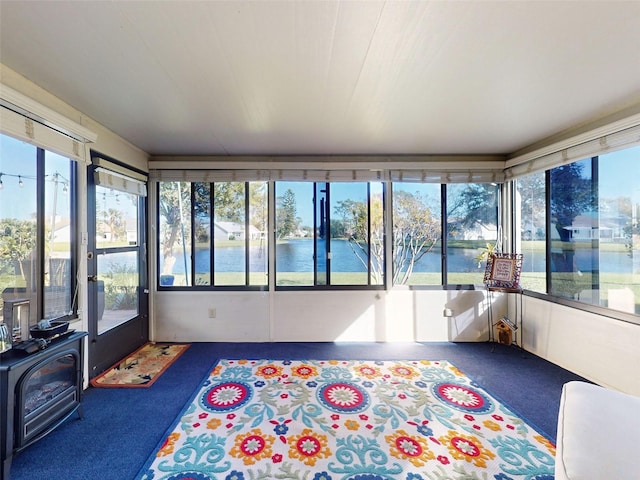 unfurnished sunroom featuring a water view