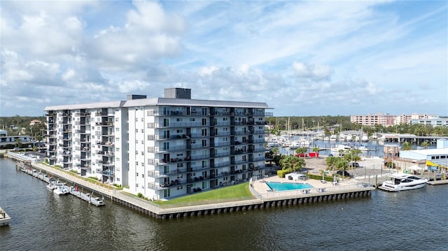 exterior space featuring a community pool and a water view