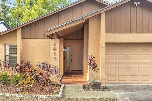 doorway to property with a garage