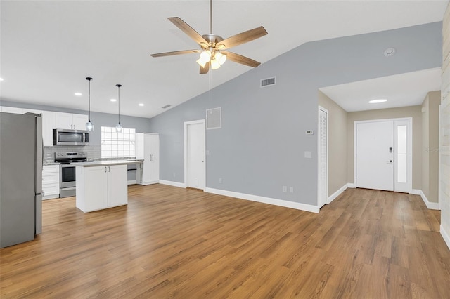 kitchen featuring stainless steel appliances, light hardwood / wood-style floors, a center island, white cabinets, and pendant lighting