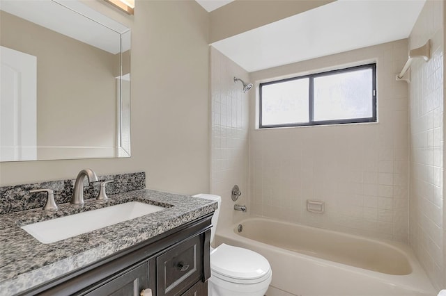 full bathroom featuring tiled shower / bath, toilet, and vanity