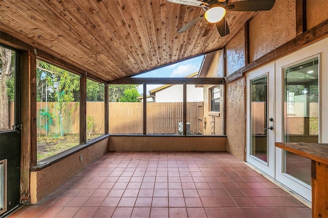 unfurnished sunroom with wood ceiling, vaulted ceiling, and ceiling fan