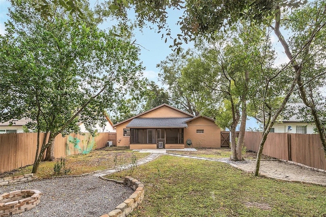 back of house featuring a sunroom