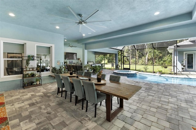 dining space featuring ceiling fan and a textured ceiling