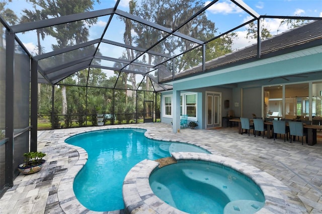 view of swimming pool featuring an in ground hot tub, a bar, glass enclosure, and a patio area