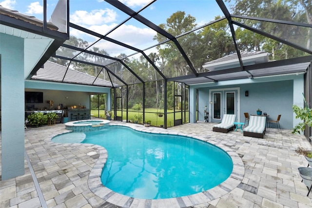 view of swimming pool featuring french doors, an in ground hot tub, a patio area, and a lanai