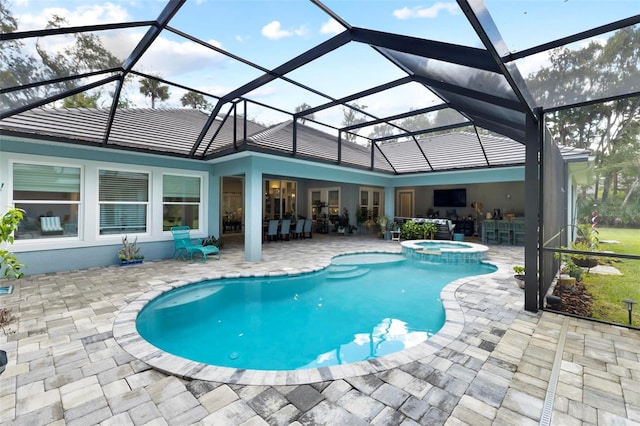 view of pool with a lanai, a patio area, and a bar