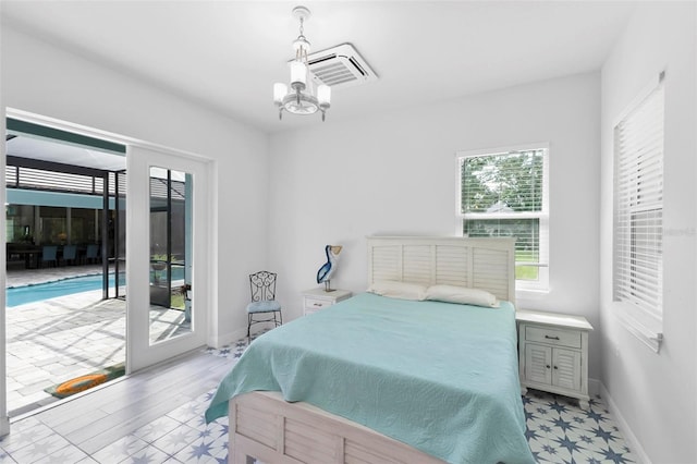 bedroom with light hardwood / wood-style flooring, access to outside, and a chandelier