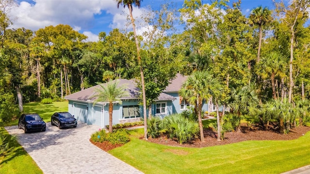 view of front of property with a front yard and a garage