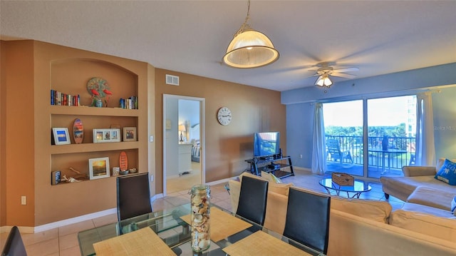 tiled living room with built in shelves and ceiling fan