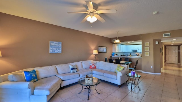 tiled living room featuring ceiling fan