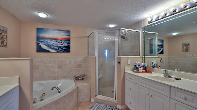 bathroom with shower with separate bathtub, vanity, a textured ceiling, and tile patterned floors