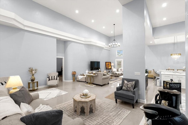 living room featuring a notable chandelier and a towering ceiling