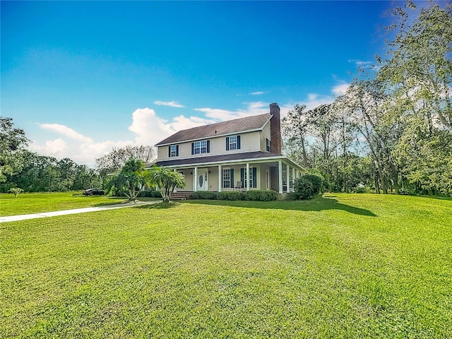 view of front of house featuring covered porch and a front yard