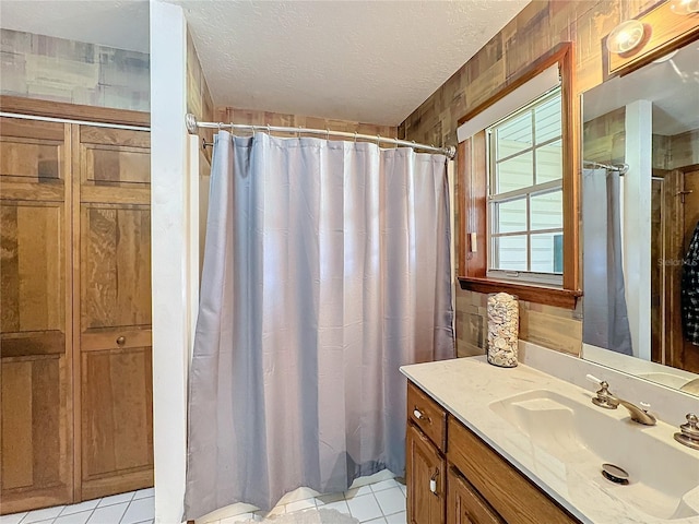 bathroom with vanity, a textured ceiling, and tile patterned floors