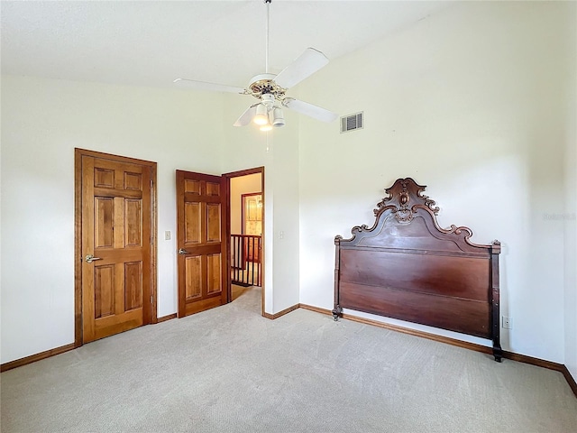 unfurnished bedroom with carpet floors, high vaulted ceiling, and ceiling fan