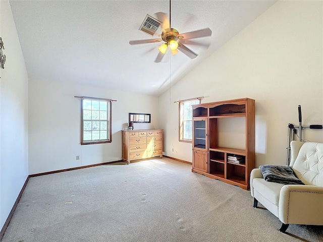 unfurnished room with ceiling fan, light colored carpet, and high vaulted ceiling