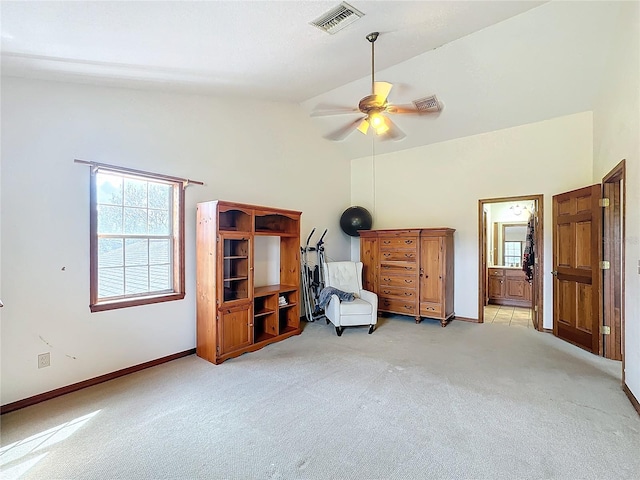 carpeted bedroom featuring high vaulted ceiling, ensuite bath, and ceiling fan