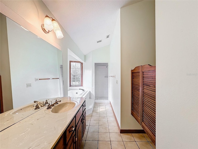 bathroom featuring a bathing tub, tile patterned flooring, a textured ceiling, vaulted ceiling, and vanity