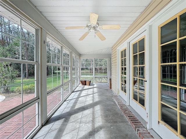 unfurnished sunroom featuring vaulted ceiling, ceiling fan, and wooden ceiling