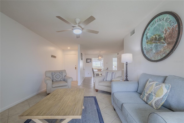 tiled living room with ceiling fan