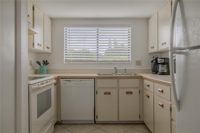 kitchen featuring white cabinets, sink, white appliances, and light tile patterned floors