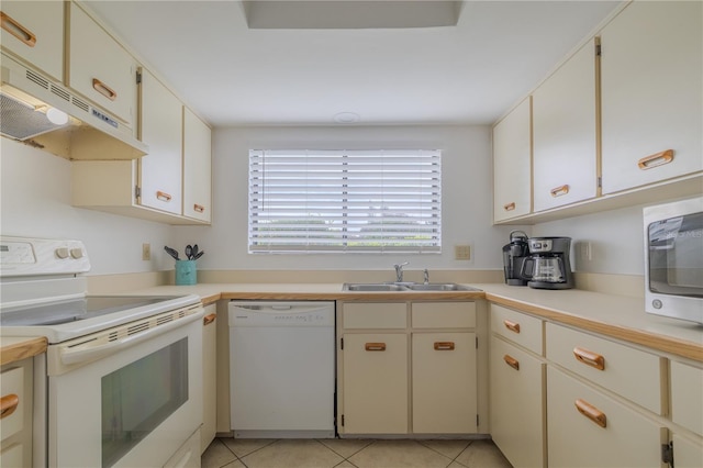 kitchen with white cabinetry, white appliances, sink, and light tile patterned floors