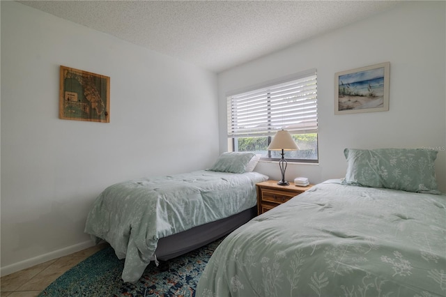 bedroom featuring tile patterned flooring and a textured ceiling