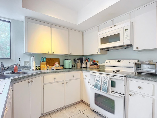 kitchen featuring white cabinets, sink, white appliances, and light tile patterned flooring