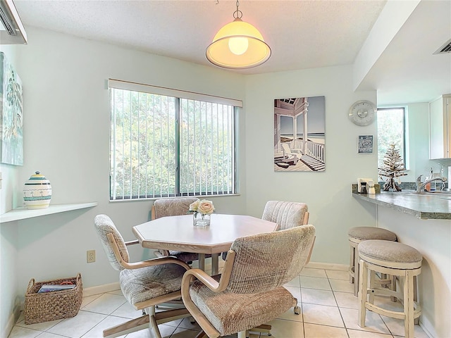 tiled dining room featuring sink