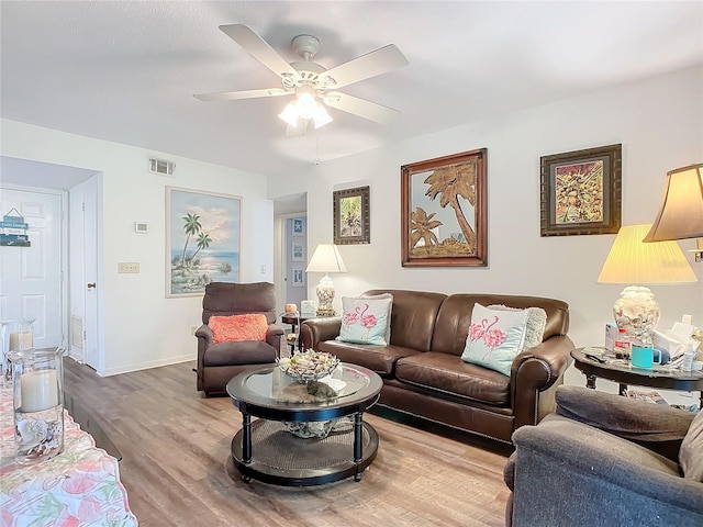 living room featuring wood-type flooring and ceiling fan