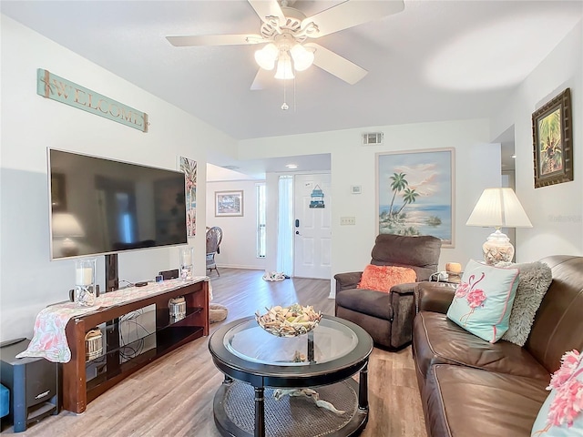 living room featuring ceiling fan and light hardwood / wood-style flooring