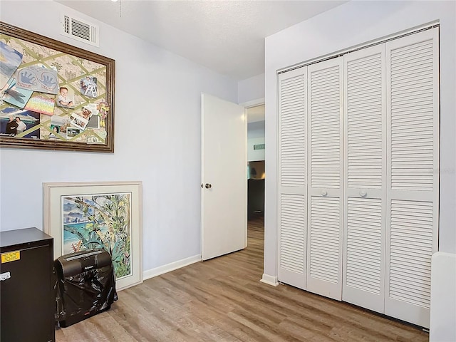 office featuring light hardwood / wood-style flooring and a textured ceiling