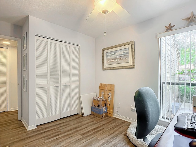 home office with ceiling fan, wood-type flooring, and a textured ceiling