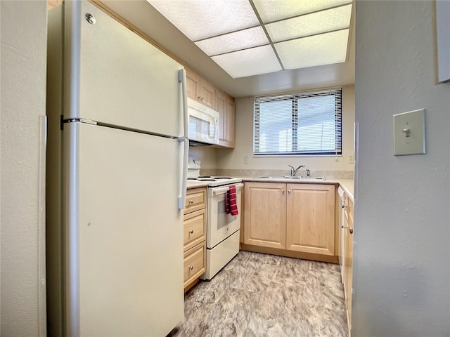 kitchen featuring light brown cabinets, white appliances, and sink