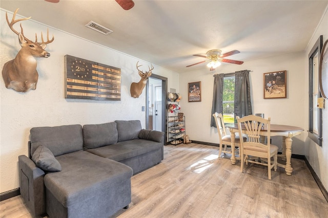 living room with ceiling fan and light hardwood / wood-style floors