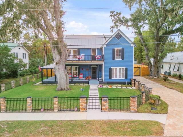 view of front of house with a front lawn, covered porch, and a balcony