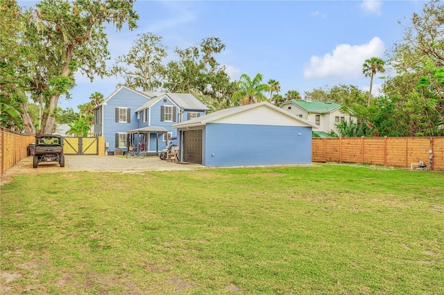 rear view of property with an outbuilding, a garage, and a yard