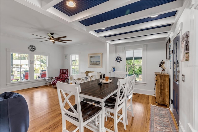 dining room featuring ornamental molding, ceiling fan, light hardwood / wood-style floors, and beamed ceiling