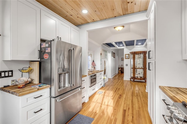 kitchen with wooden counters, white cabinetry, appliances with stainless steel finishes, wood ceiling, and light hardwood / wood-style floors