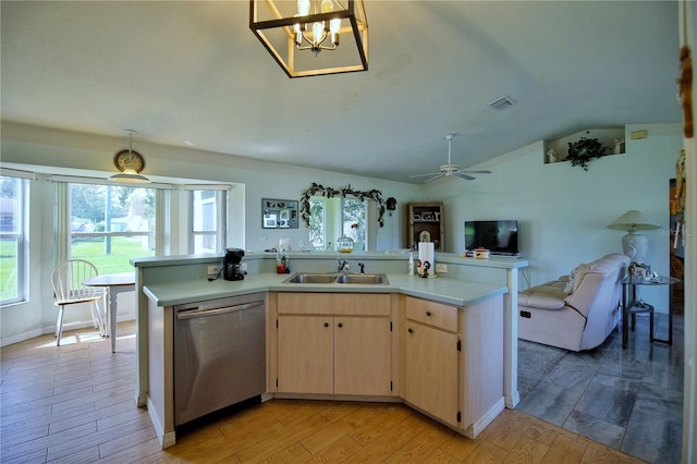 kitchen with light hardwood / wood-style floors, lofted ceiling, sink, stainless steel dishwasher, and light brown cabinetry