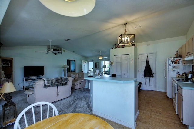 kitchen with light brown cabinets, pendant lighting, light hardwood / wood-style floors, lofted ceiling, and white electric range