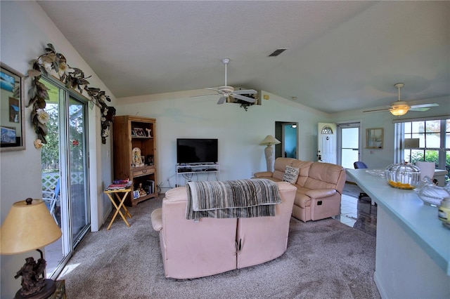 carpeted living room with lofted ceiling and ceiling fan