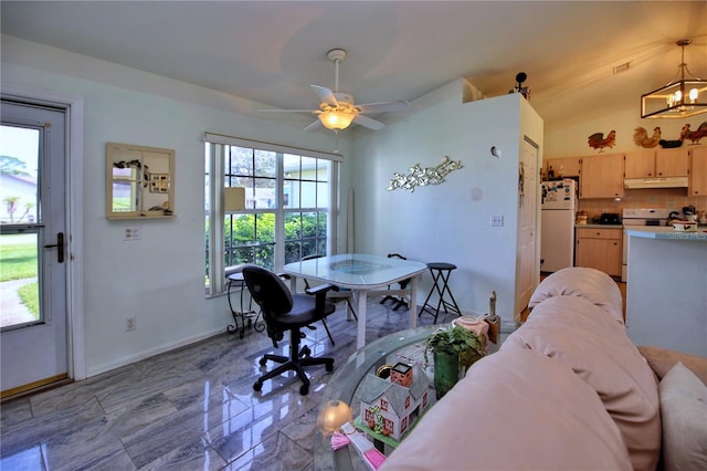 dining area with ceiling fan with notable chandelier and lofted ceiling