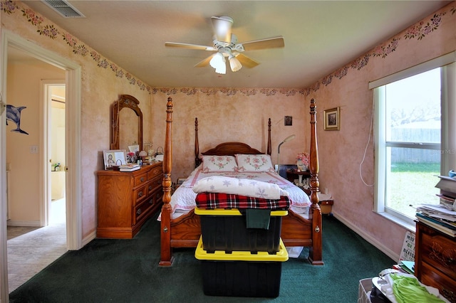 bedroom with ceiling fan and dark carpet