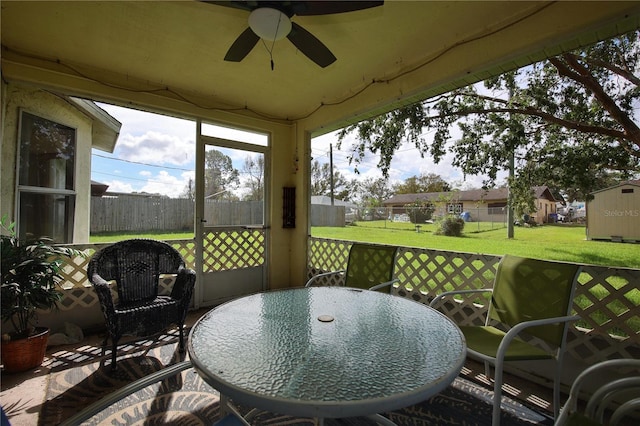 sunroom featuring ceiling fan